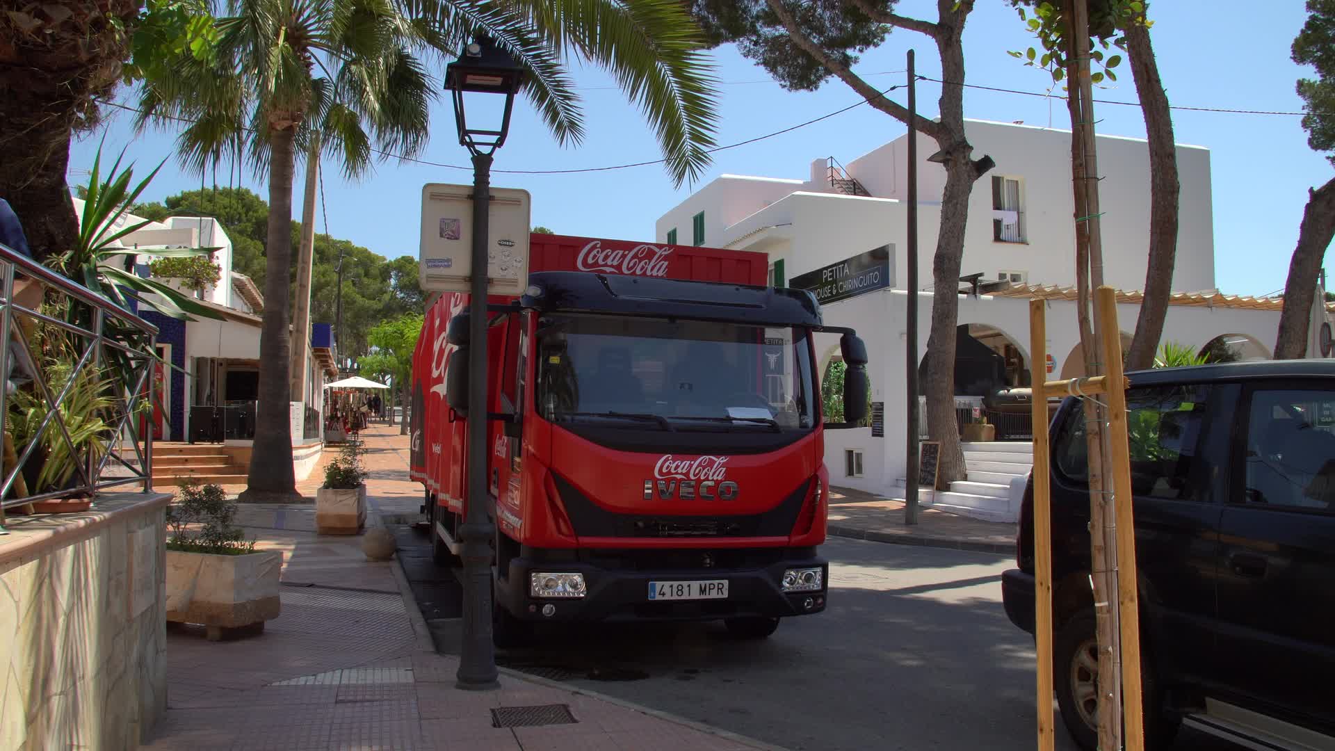 Coca-Cola Delivery Truck on Sunny Street in Cala d'Or, Mallorca, Spain