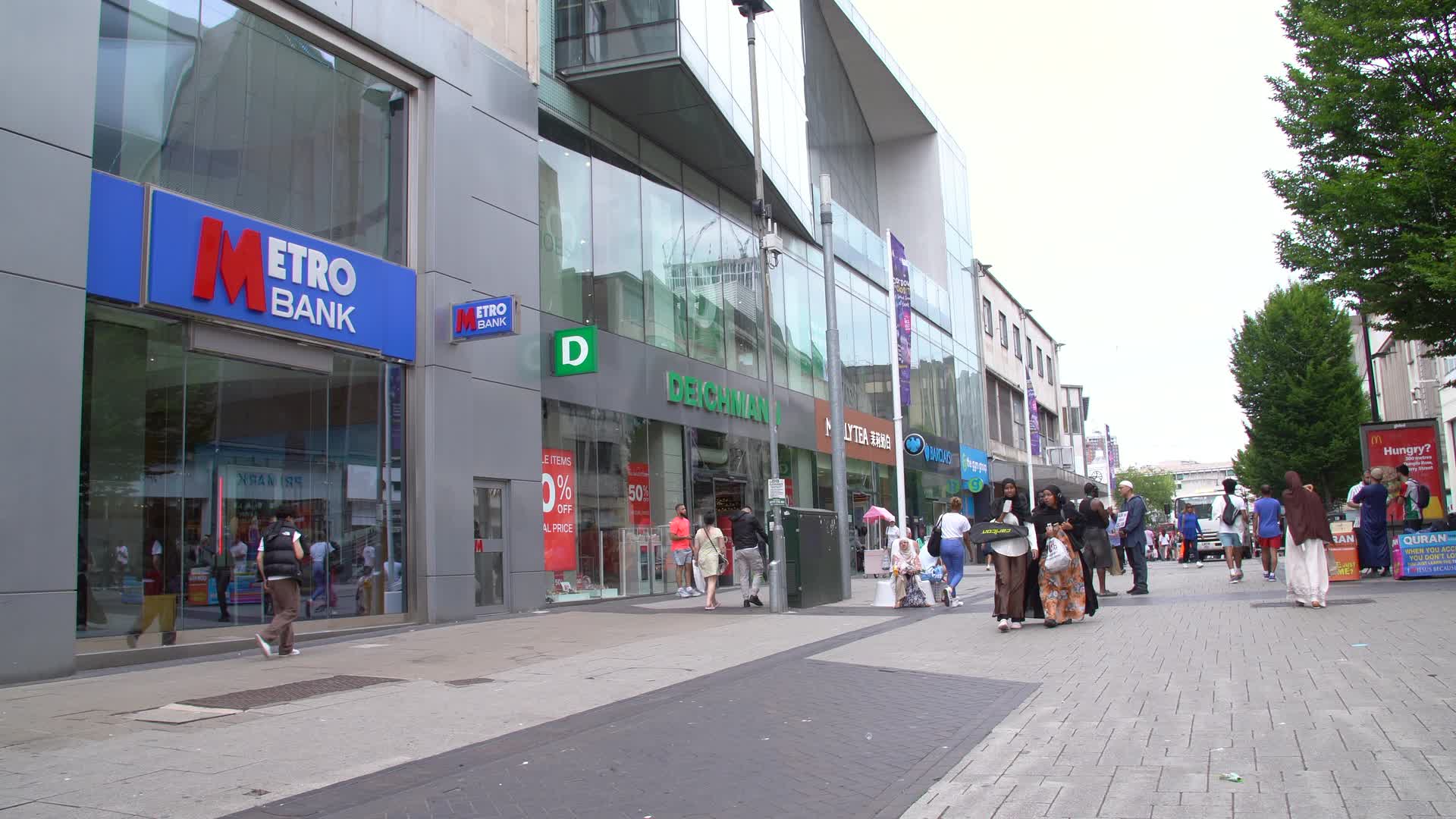 Busy Shopping Street with Metro Bank in Urban Setting