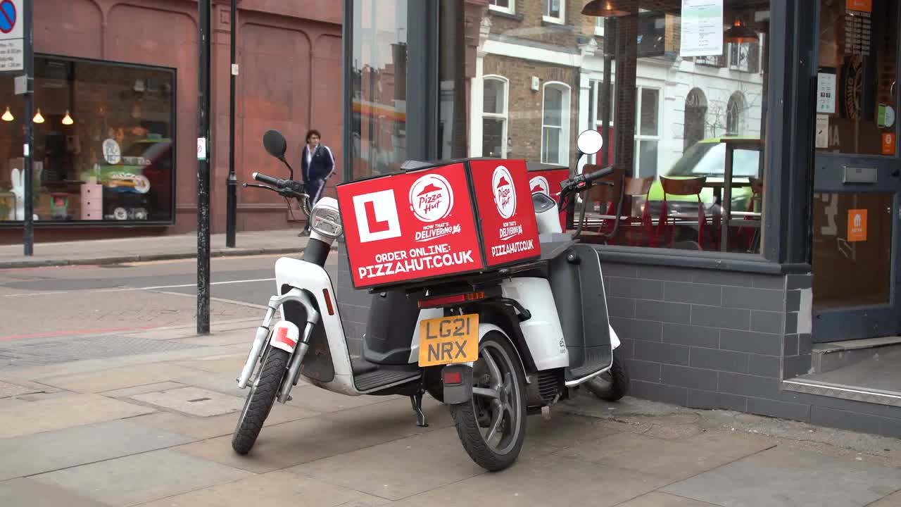 Pizza Hut Delivery Scooter on Urban Street
