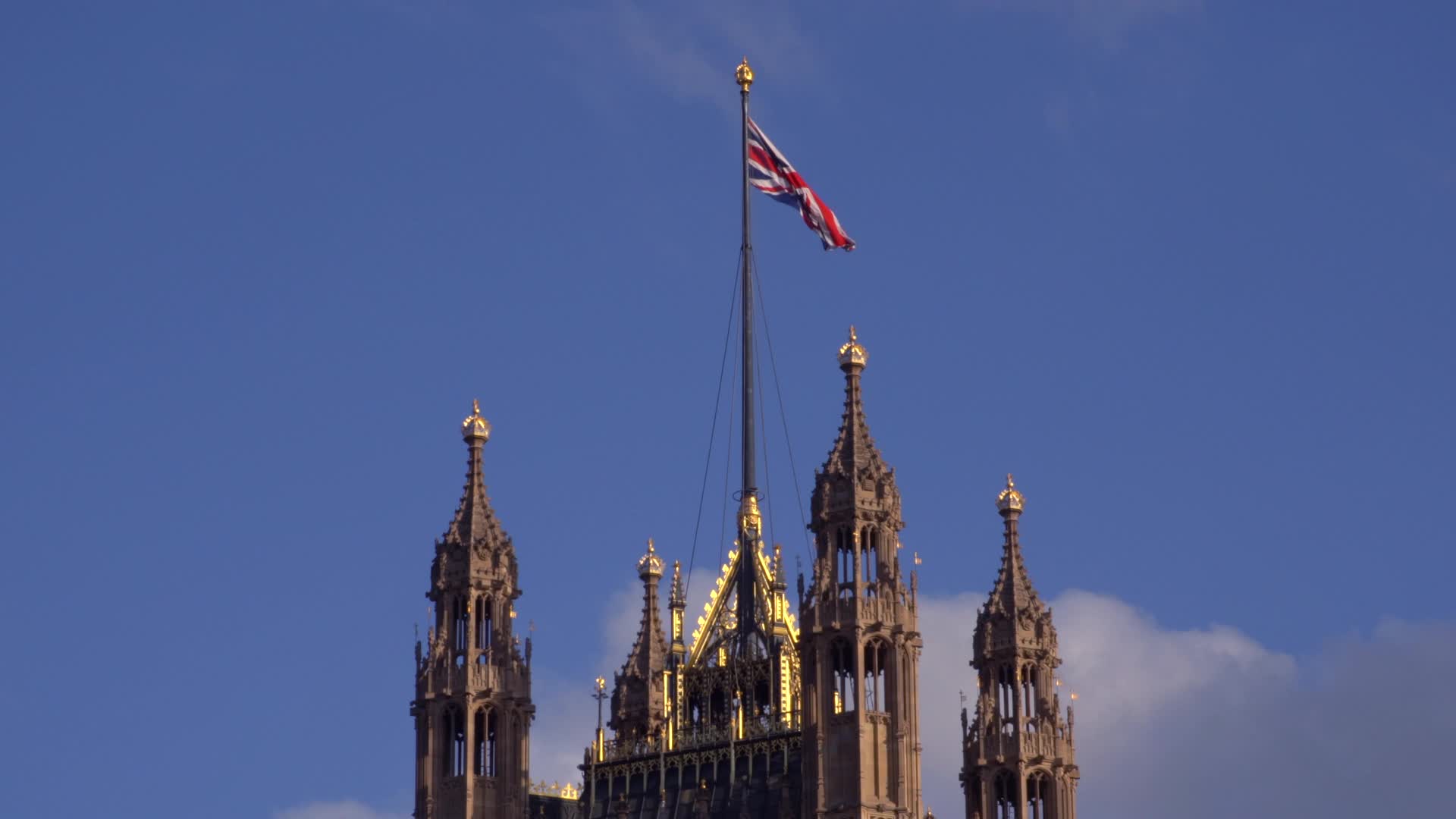 UK Parliament Tower and Union Jack on a Sunny Day