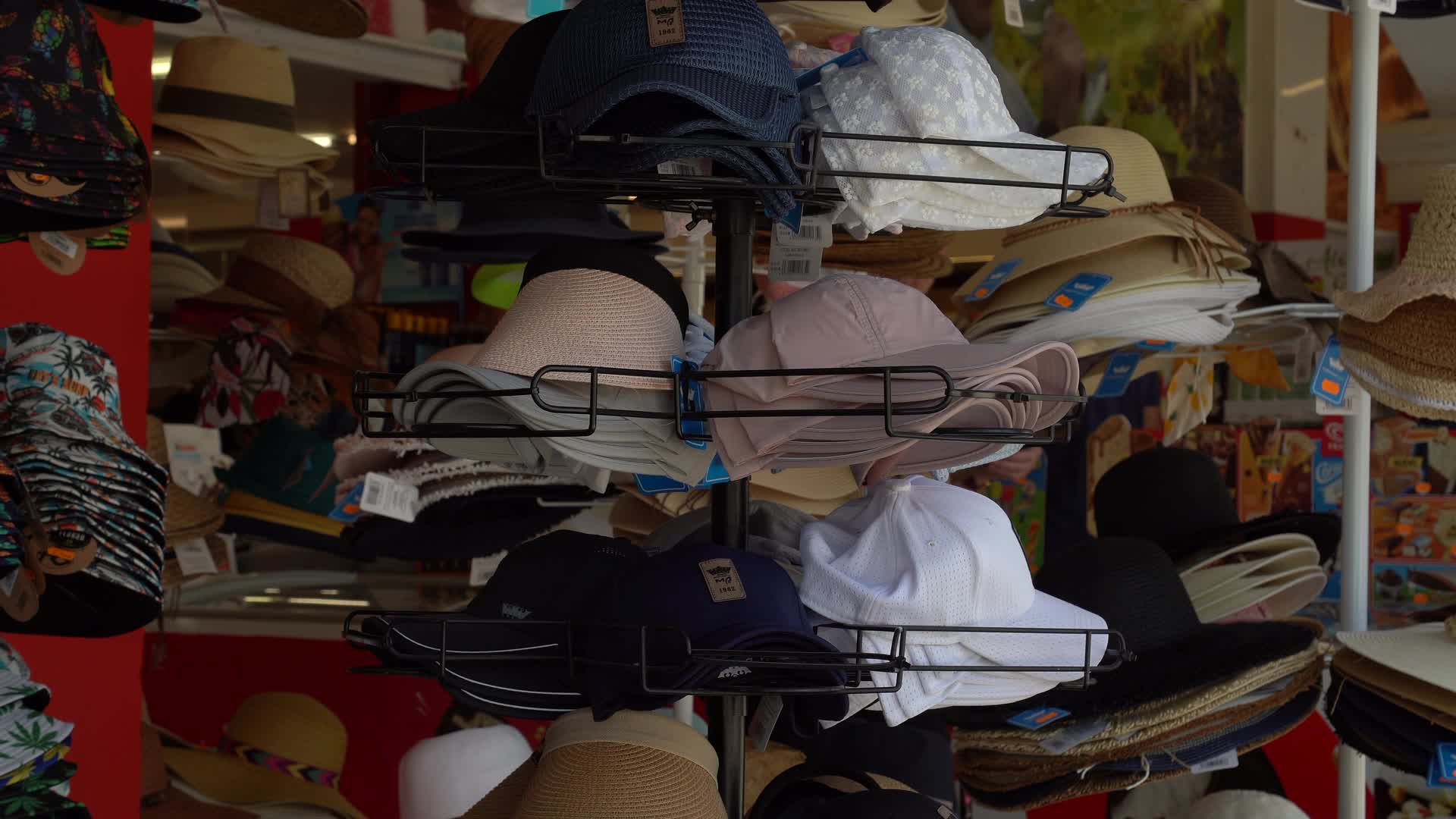 Assorted Sun Hats on Display in SPAR Supermarket in Cala d'Or, Mallorca, Spain