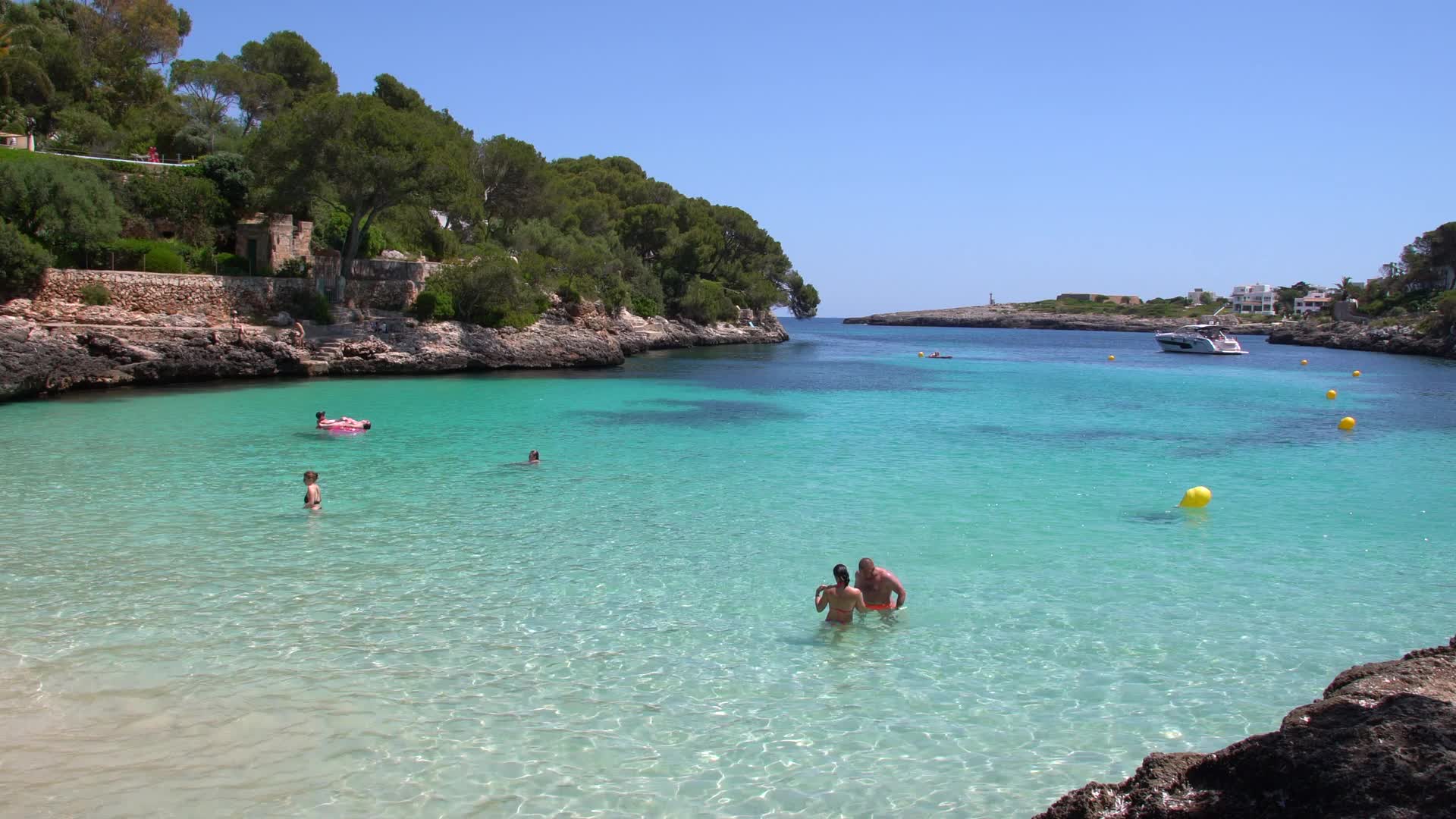 Summer Day on a Scenic Beach in Cala d'Or, Mallorca, Spain - Blue Water and Tourists