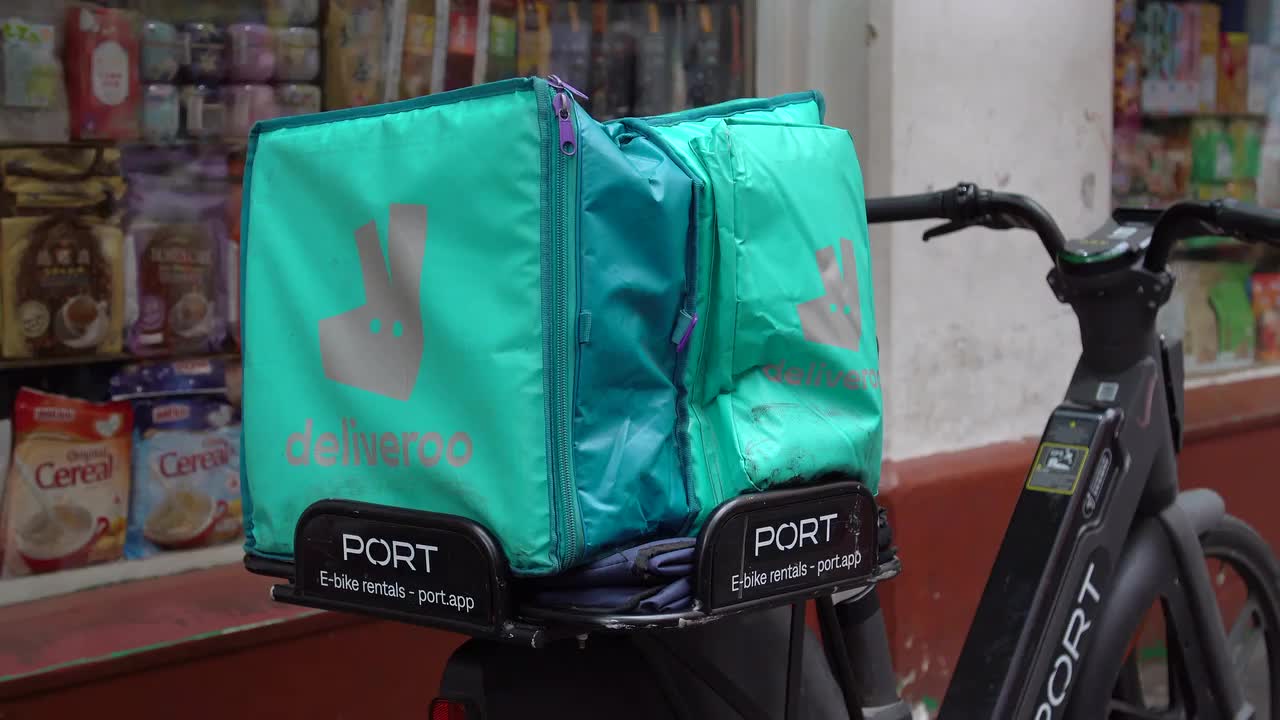 Deliveroo Rider with Port E-Bike at Local Store