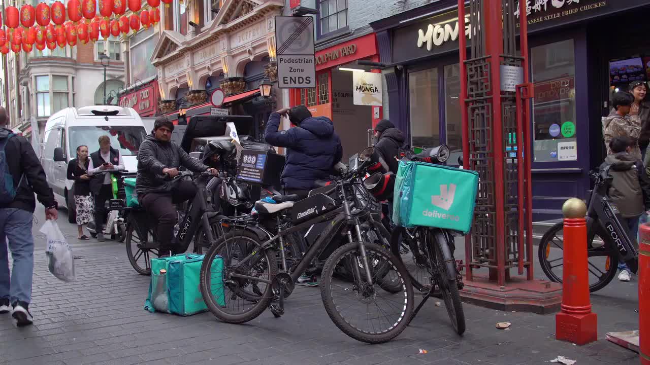 Urban Food Delivery Couriers on Bicycles in Chinatown